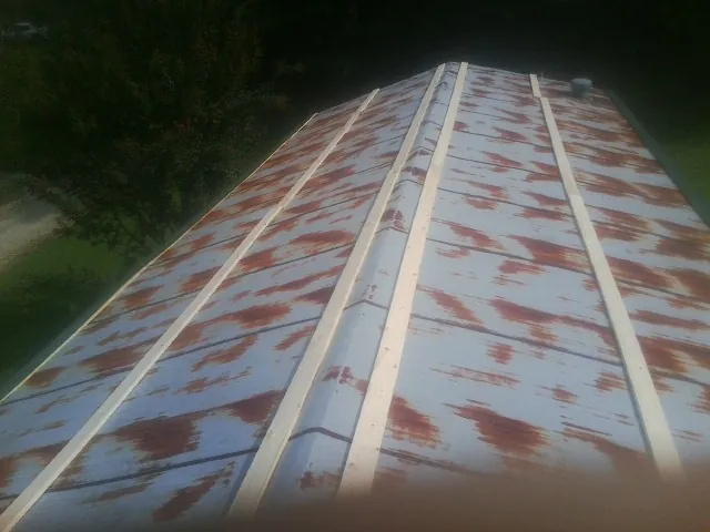 Rusted metal roof panels with new wood purlins before replacement — Storm Damage Roof Repair in Leiters Ford by Roofing Brothers